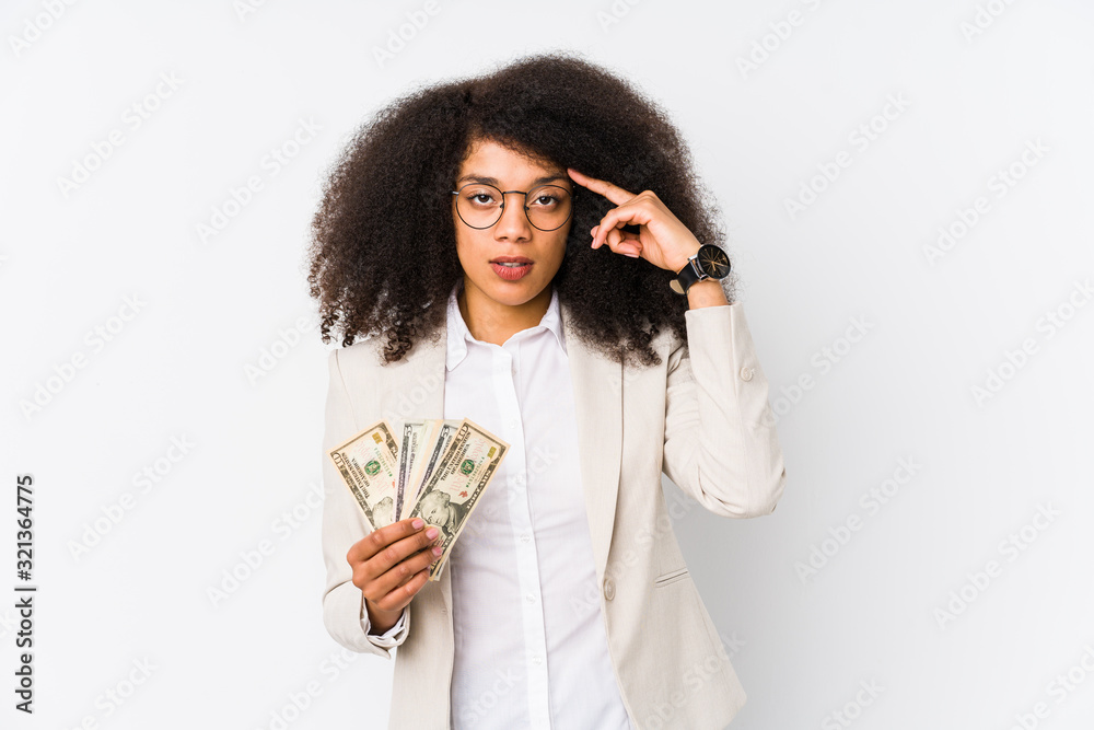 Young afro business woman holding a credit car isolated Young afro business woman holding a credit carpointing temple with finger, thinking, focused on a task. Young afro business woman holding a credit car isolated Young afro business woman holding a credit carpointing temple with finger, thinking, focused on a task.