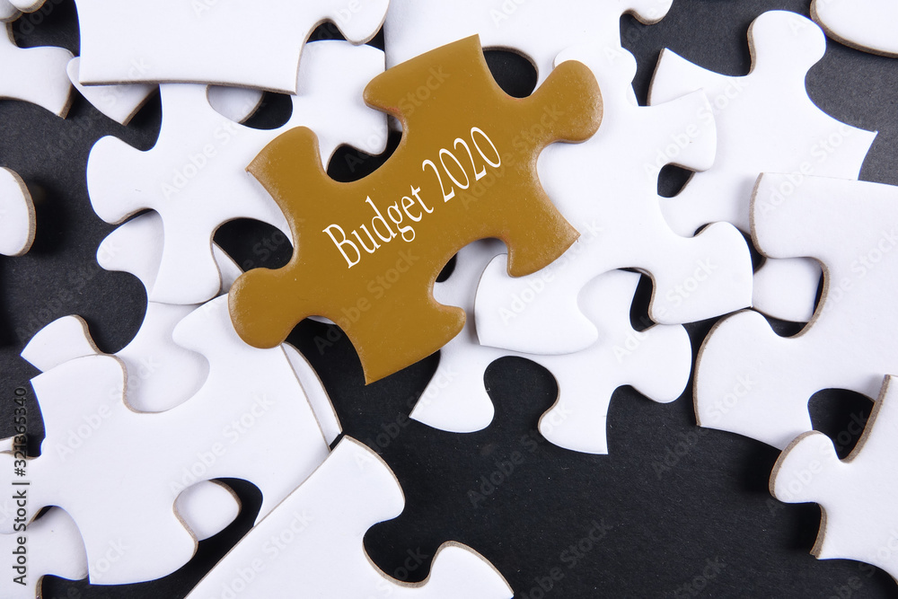 Budget 2020 printed on gold puzzle over white puzzle background Budget 2020 printed on gold puzzle over white puzzle background