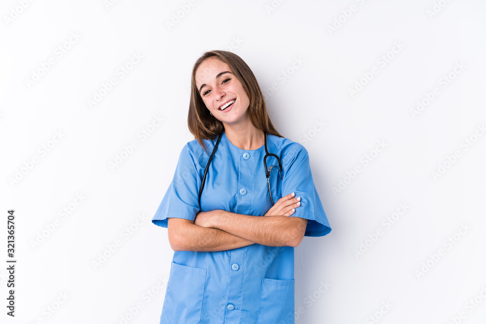 Young nurse woman isolated laughing and having fun.
