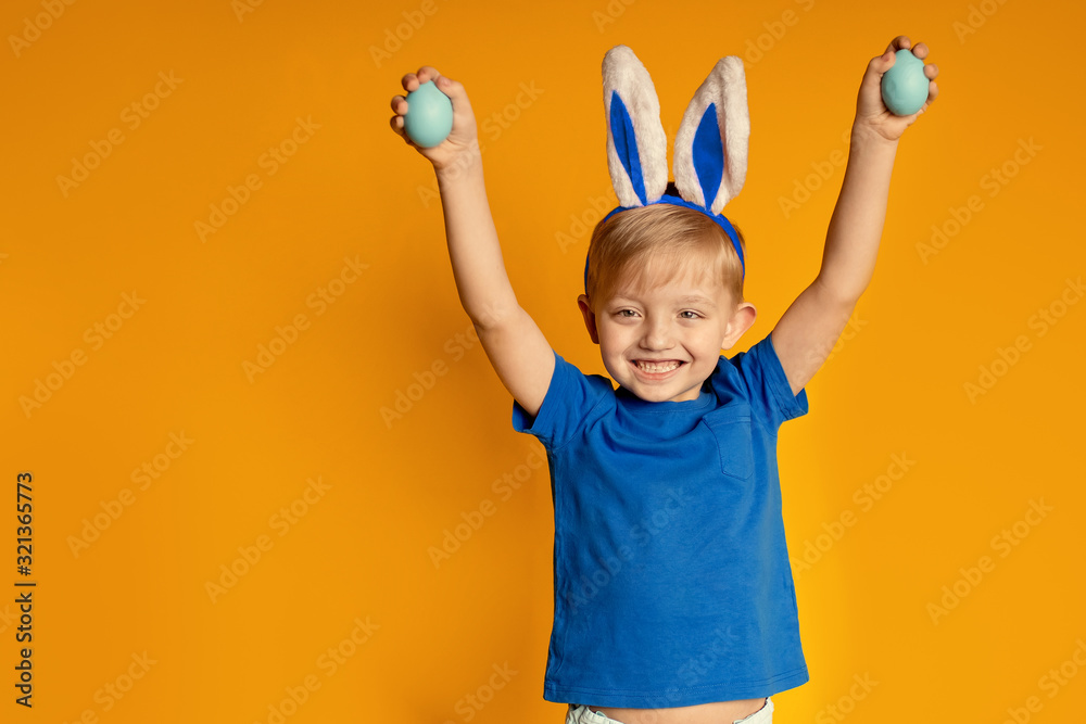 funny happy boy on a yellow background, easter theme funny happy boy on a yellow background, easter theme