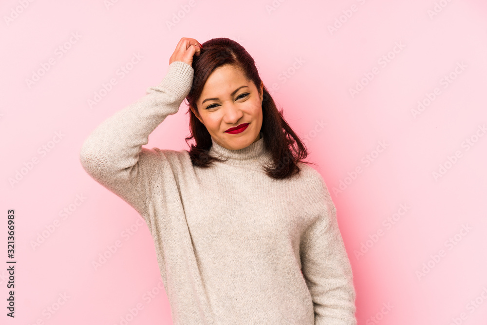 Middle age latin woman isolated on a pink background tired and very sleepy keeping hand on head. Middle age latin woman isolated on a pink background tired and very sleepy keeping hand on head.