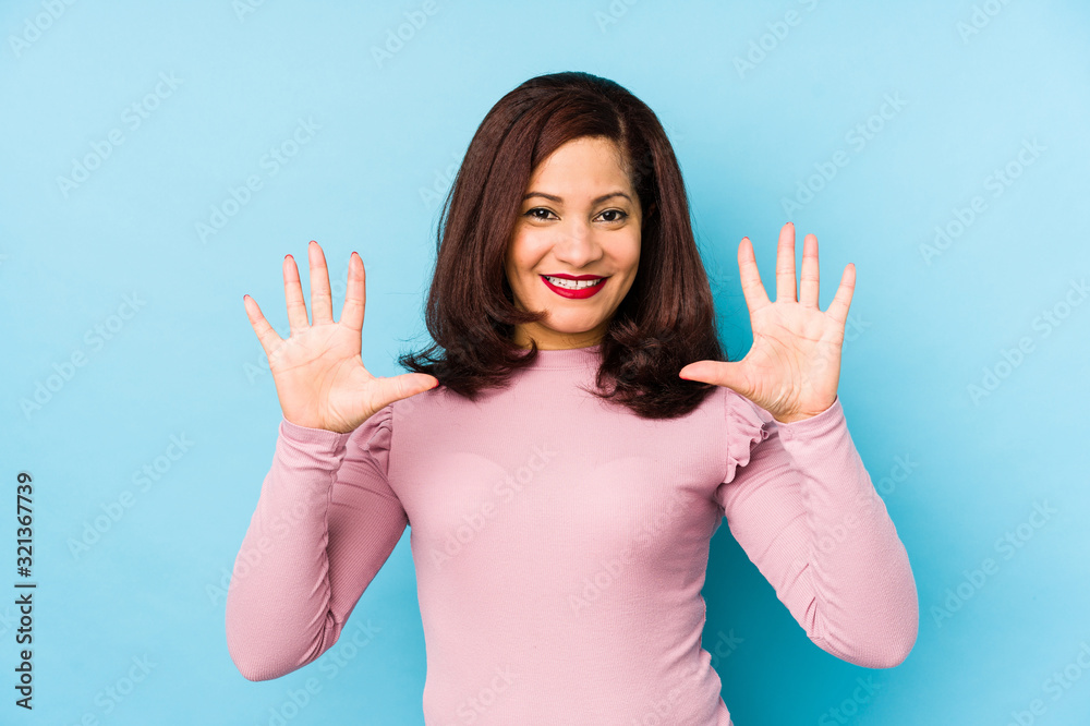 Middle age latin woman isolated showing number ten with hands. Middle age latin woman isolated showing number ten with hands.