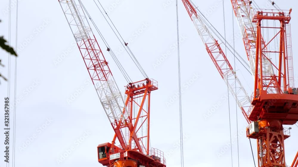 The red long industrial cranes on the site in Tokyo Japan The red long industrial cranes on the site in Tokyo Japan
