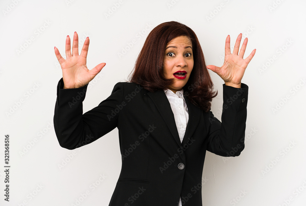 Middle age latin business woman isolated being shocked due to an imminent danger Middle age latin business woman isolated being shocked due to an imminent danger