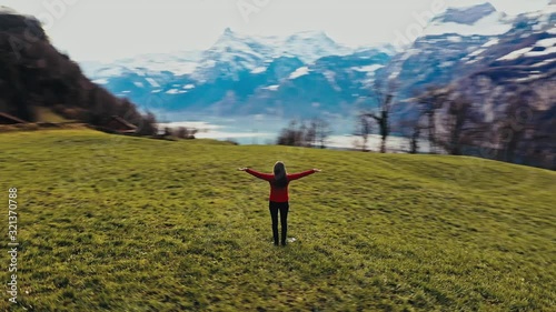 Mountain landscape. Figure of a woman with open hands. Joy enjoyment of nature. Switzerland, Alps.