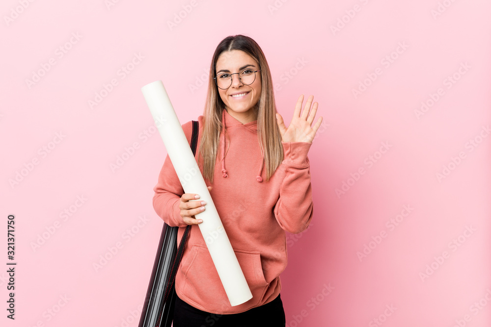 Young woman studying architecture smiling cheerful showing number five with fingers.