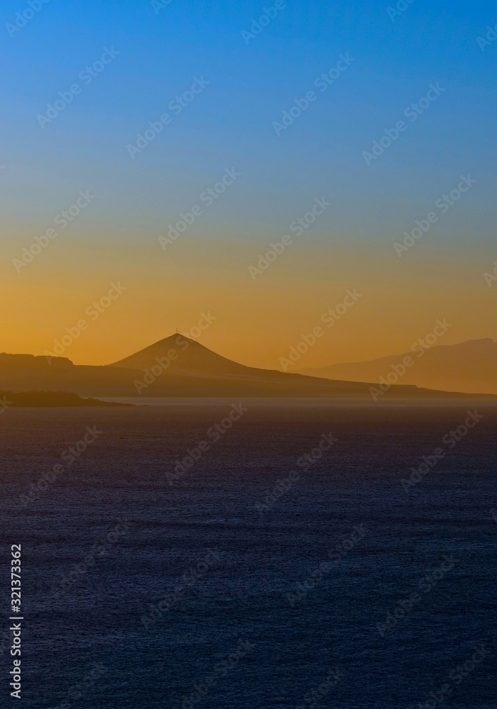 Vertical panoramic image of spectacular sky colors and sunset landscape of a volcanic island.