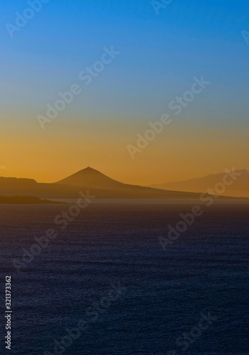 Vertical panoramic image of spectacular sky colors and sunset landscape of a volcanic island.