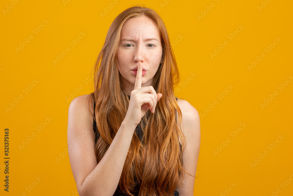 Close up of a beautiful amazing she her foxy lady hold arm hand index finger mouth lips ask stop talking tell speak say secrecy information on yellow background. Close up of a beautiful amazing she her foxy lady hold arm hand index finger mouth lips ask stop talking tell speak say secrecy information on yellow background.
