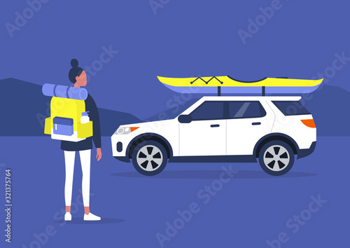 Outdoor active leisure: young female backpacker on a weekend trip, kayaking, hiking