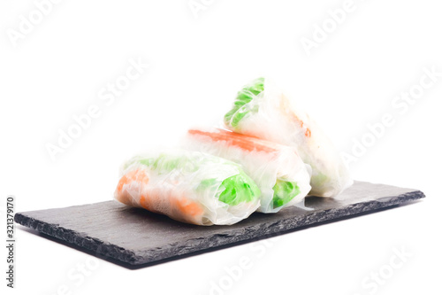 High key photo of Gỏi cuốn or Vietnamese spring roll on slate plate. Traditional Vietnamese consisting of meat, prawn, vegetables, rice vermicelli and other ingredients wrapped in rice paper.