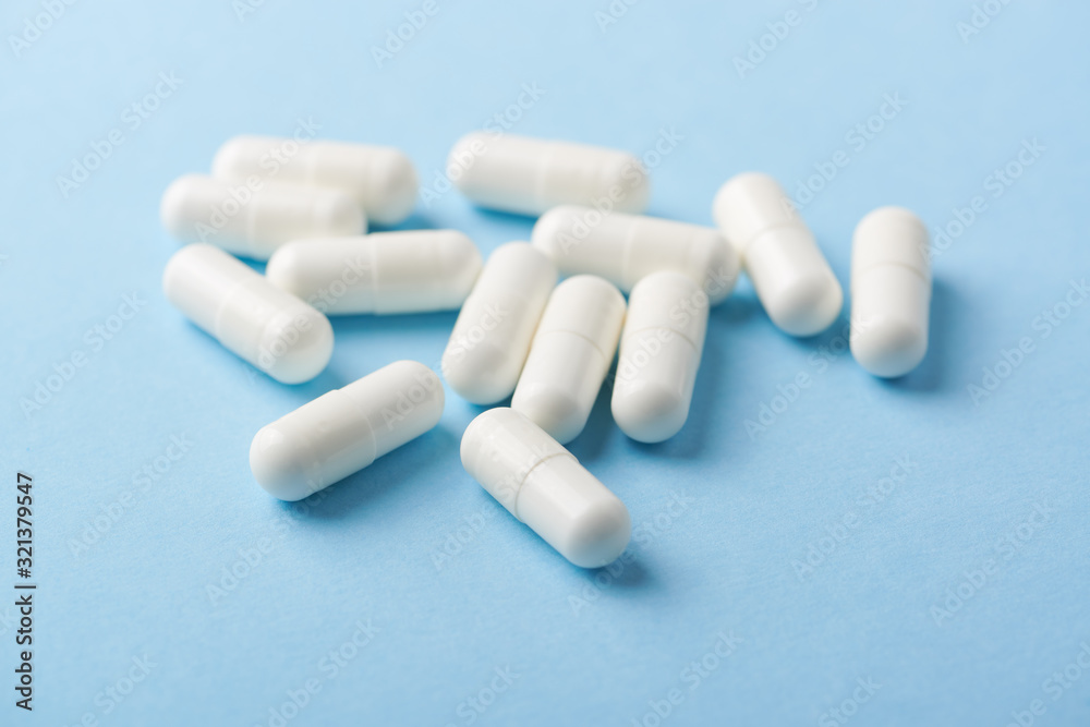 Leucine amino acid. Fitness supplement on bright paper background. Close up. Leucine amino acid. Fitness supplement on bright paper background. Close up.