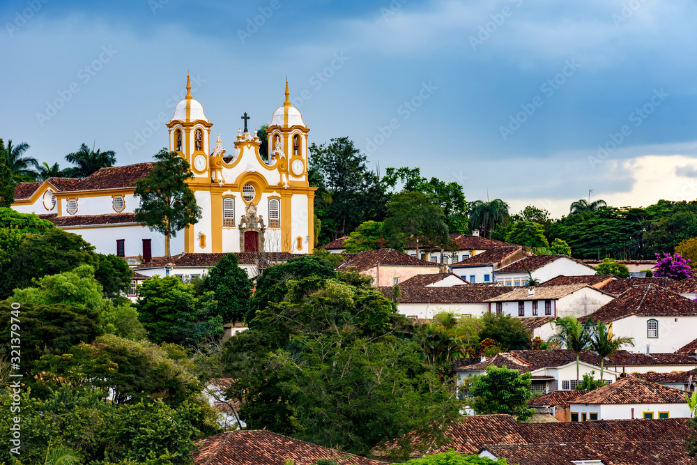 Church and cityscape of the old and famous city of Tiradentes in Minas Gerais with its houses, churches, mountains and vegetation