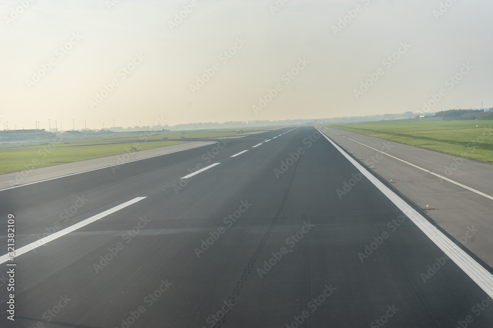Amsterdam Schiphol,, a highway with cars parked on the side of a road airport runway