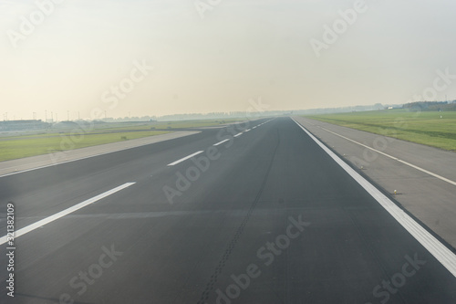 Amsterdam Schiphol,, a highway with cars parked on the side of a road airport runway © SkandaRamana