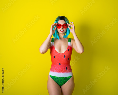 Fototapeta Portrait of a woman in a swimsuit with a picture of a watermelon