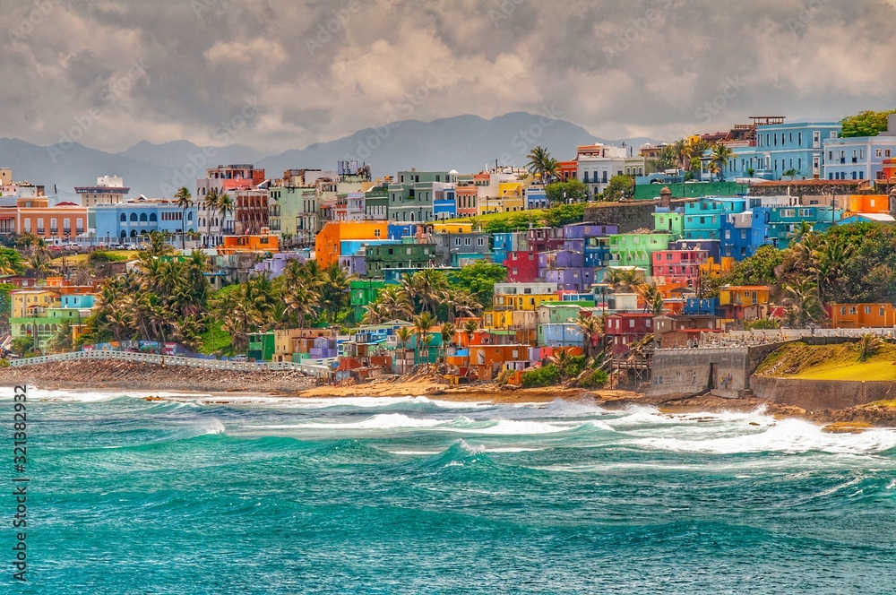 Colorful houses line the hillside over looking the beach in San Juan ...