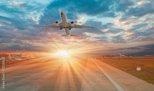 A Passenger airplane fly up over take-off runway from airport