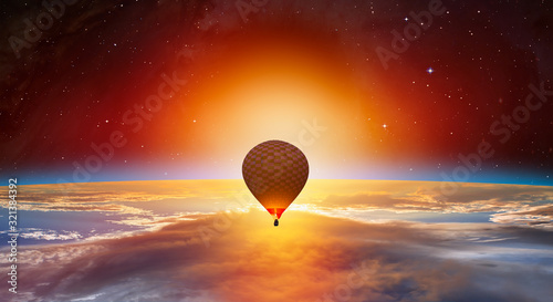 Fototapeta Naklejka Na Ścianę i Meble -  Hot air balloon on the foreground Planet Earth with a spectacular sunset 