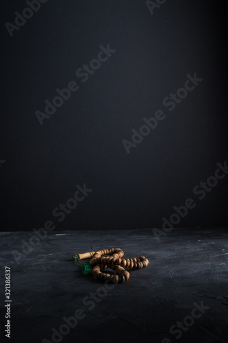 Faith in Islam, rosary beads on dark background. Islamic holiday celebration Eid Mubarak or Ramadan Kareem concept. Copy space. photo