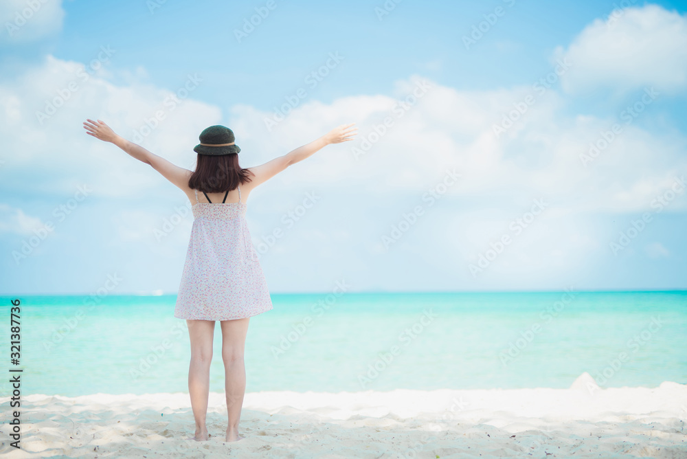 Happy traveller woman in white dress enjoys her tropical beach vacation Happy traveller woman in white dress enjoys her tropical beach vacation