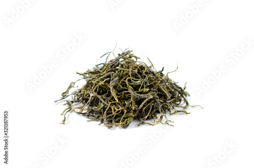Pile of dry green tea leaves on a white background close-up.