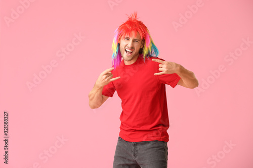 Man in funny disguise on color background. April fools  day celebration