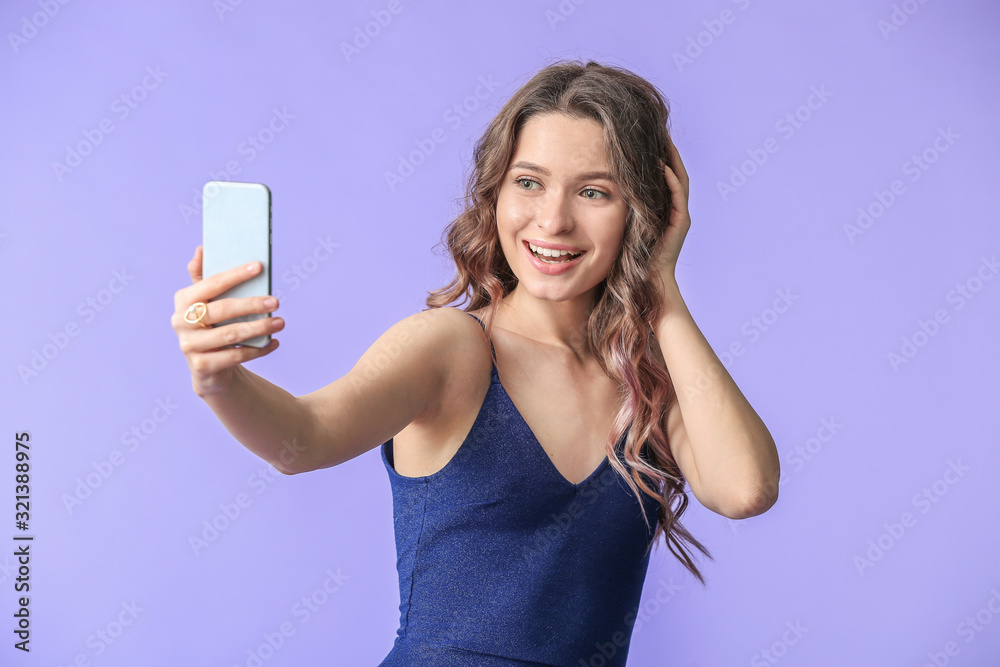 Young woman taking selfie on color background Young woman taking selfie on color background