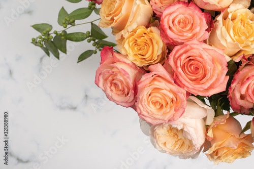Blush and pink rose bouquet flat lay on marble background