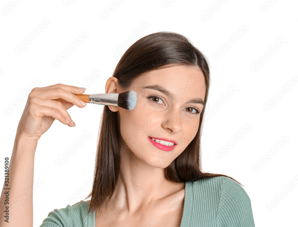 Beautiful young woman applying makeup on white background Beautiful young woman applying makeup on white background