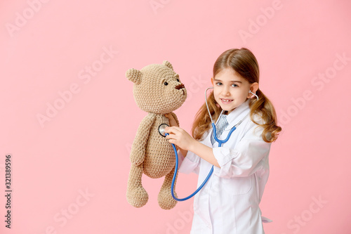 Cute little doctor with toy...