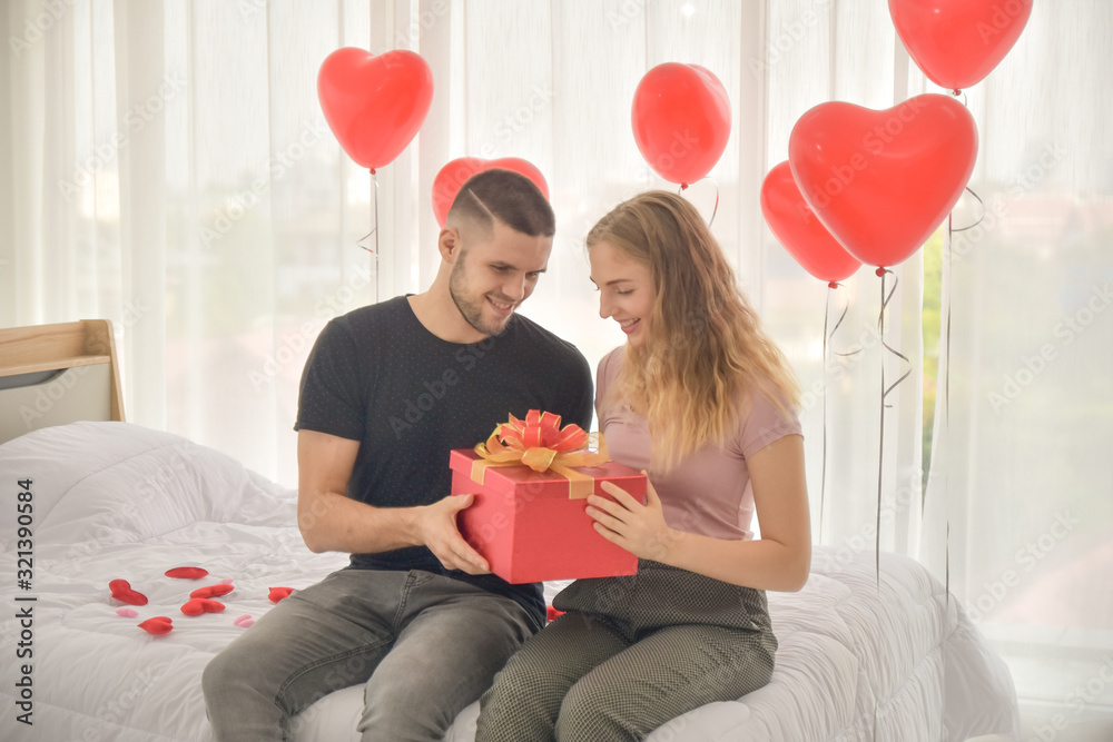 Couple giving gift box in bedroom happiness in love valentine's day concept Couple giving gift box in bedroom happiness in love valentine's day concept