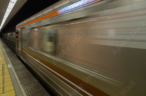 Tokyo subway station platform with motion blurred train © sean heatley