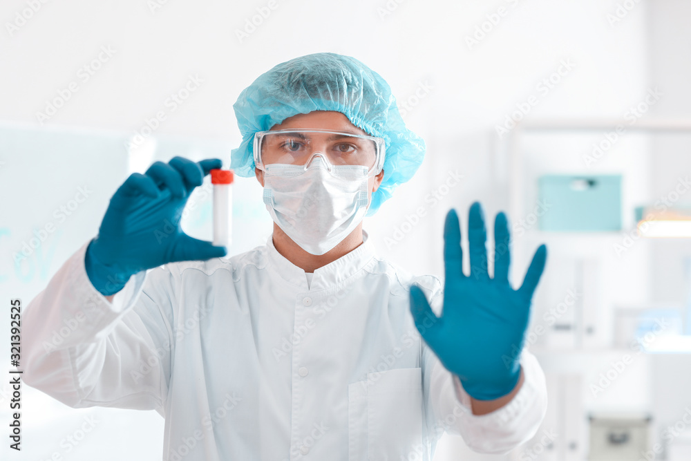 Scientist with sample in test tube in laboratory. Concept of epidemic Scientist with sample in test tube in laboratory. Concept of epidemic
