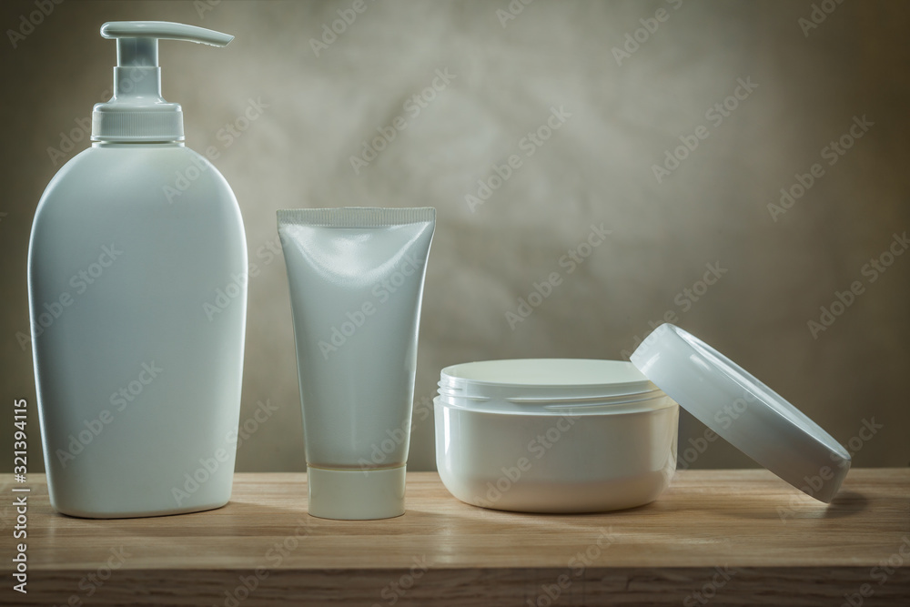 body hygiene products two pump dispensers mockup blank white plastic bottles and facial cream in opened jar on wooden table body hygiene products two pump dispensers mockup blank white plastic bottles and facial cream in opened jar on wooden table