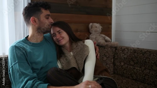Young couple hugs in a country house