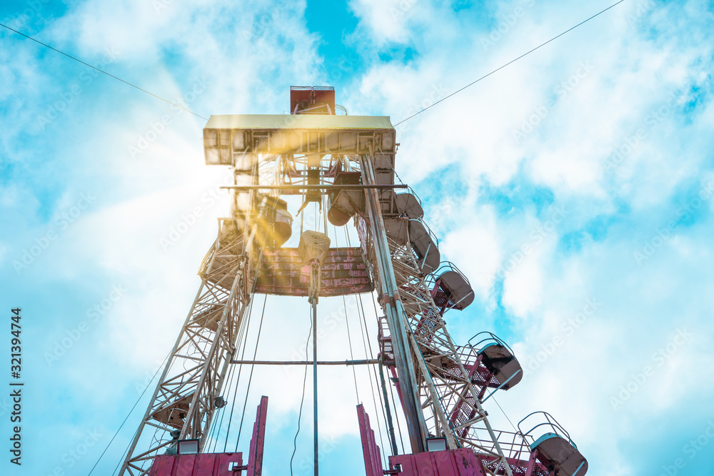 Oil and Gas Drilling Rig onshore dessert with dramatic cloudscape. Oil drilling rig operation on the oil platform in oil and gas industry Oil and Gas Drilling Rig onshore dessert with dramatic cloudscape. Oil drilling rig operation on the oil platform in oil and gas industry