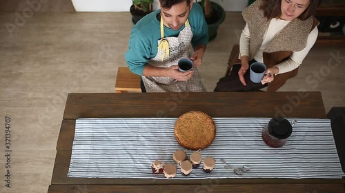 A couple has breakfast with tea and a pie.