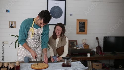 A couple laugh at breakfast