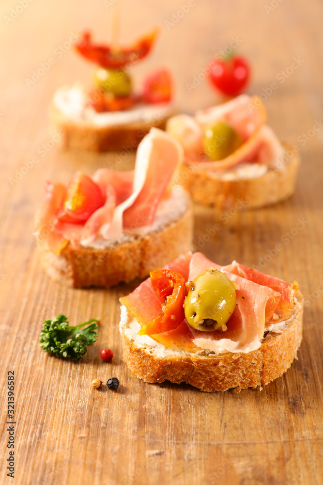 bread toast with cheese, prosciutto ham and olive bread toast with cheese, prosciutto ham and olive