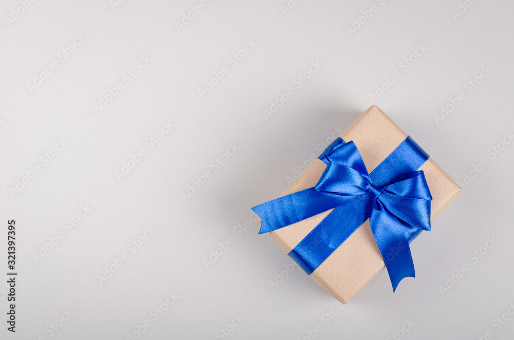 Gift box on gray background composition, present with ribbon and bow. Gift box on gray background composition, present with ribbon and bow.