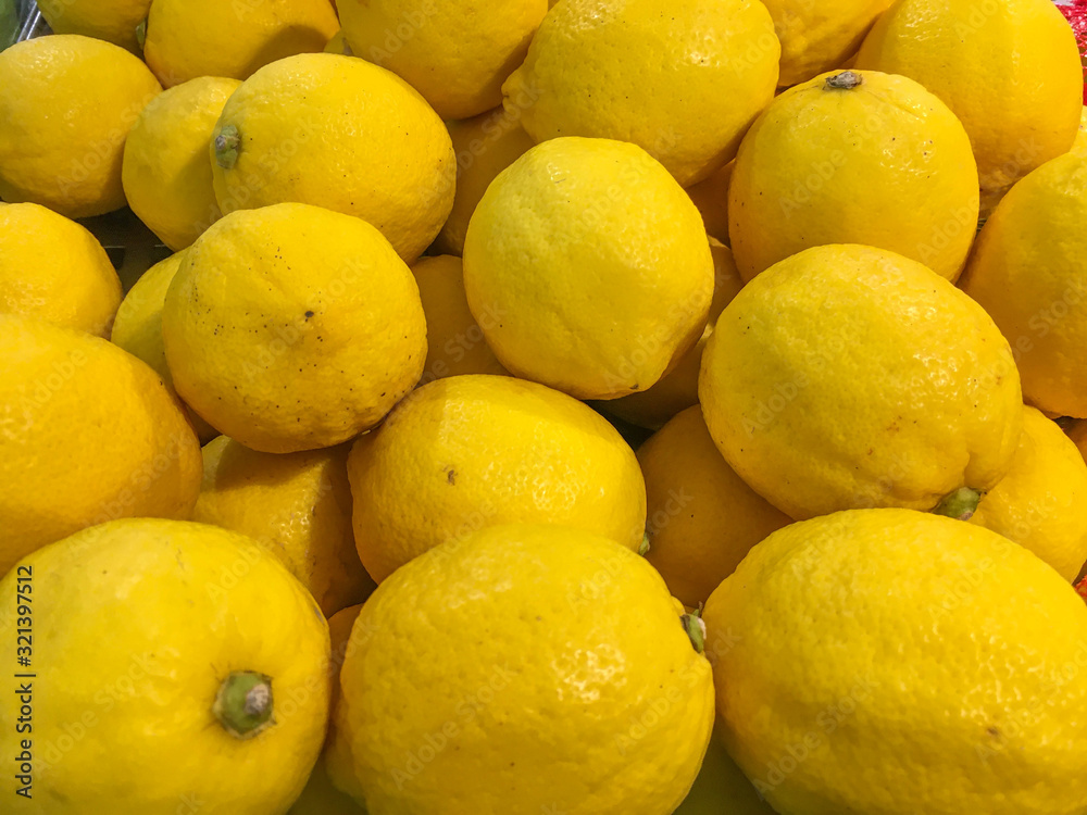 Fresh Lemons set as a background in market.Healthy eating. Fresh Lemons set as a background in market.Healthy eating.