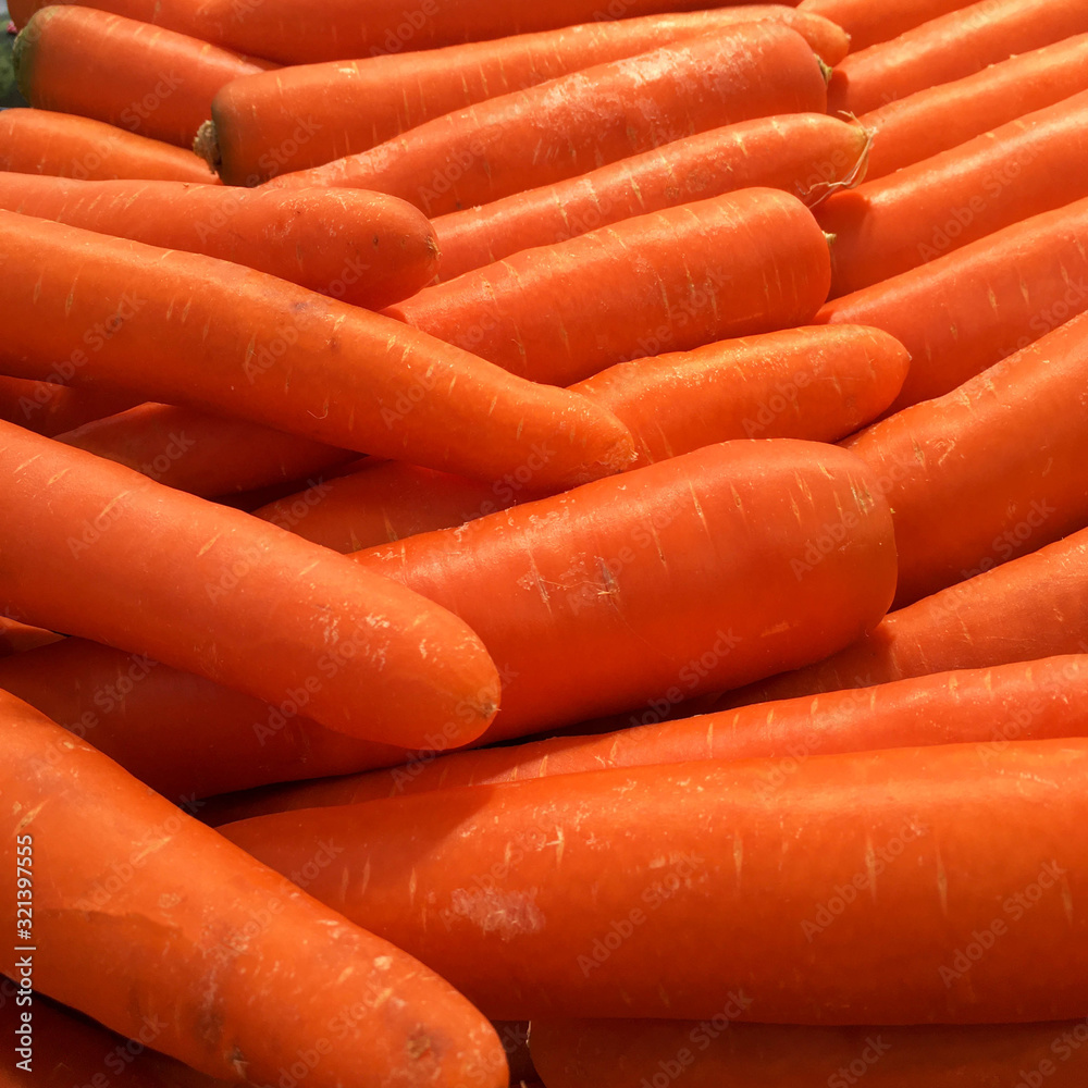 Texture background of fresh large orange carrots in the market. Texture background of fresh large orange carrots in the market.