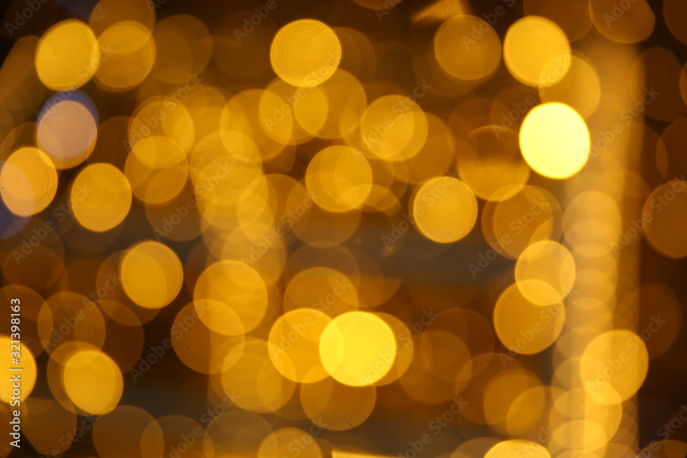 blurred golden circles of lights. defocused lights of festive garland blurred golden circles of lights. defocused lights of festive garland
