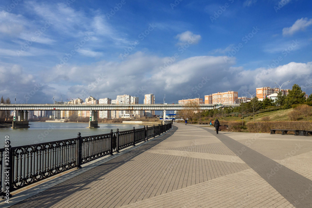autumn landscape people walk along the embankment of the Kuban river and view of the Turgenevsky bridge on an autumn morning in the city of Krasnodar