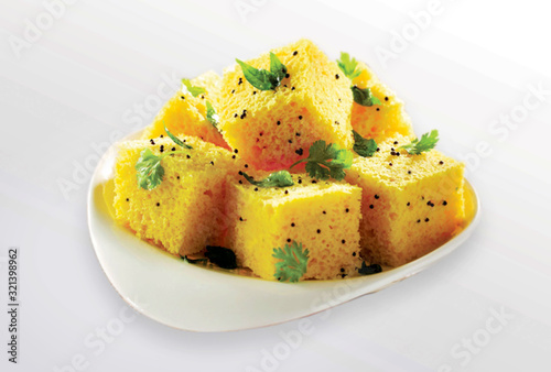 popular Indian / Gujarati dish Traditional Street Food Sev Khaman Dhokla Served With Chutney & Chilli. selective focus - Image
