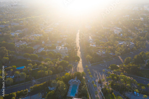 Stunning aerial view of Beverly Hills neighborhood, Beverly Hills Hotel, and Sunset Boulevard surrounded with palm trees in Los Angeles, California.