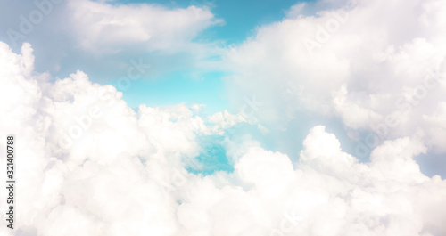 Beautiful white fluffy clouds on vivid blue pastel sky in a suny day photo