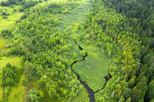 Top view of a river flowing through a wooded area