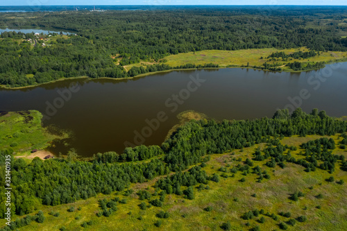 Aerial view from above on a forest lake and and its surroundings